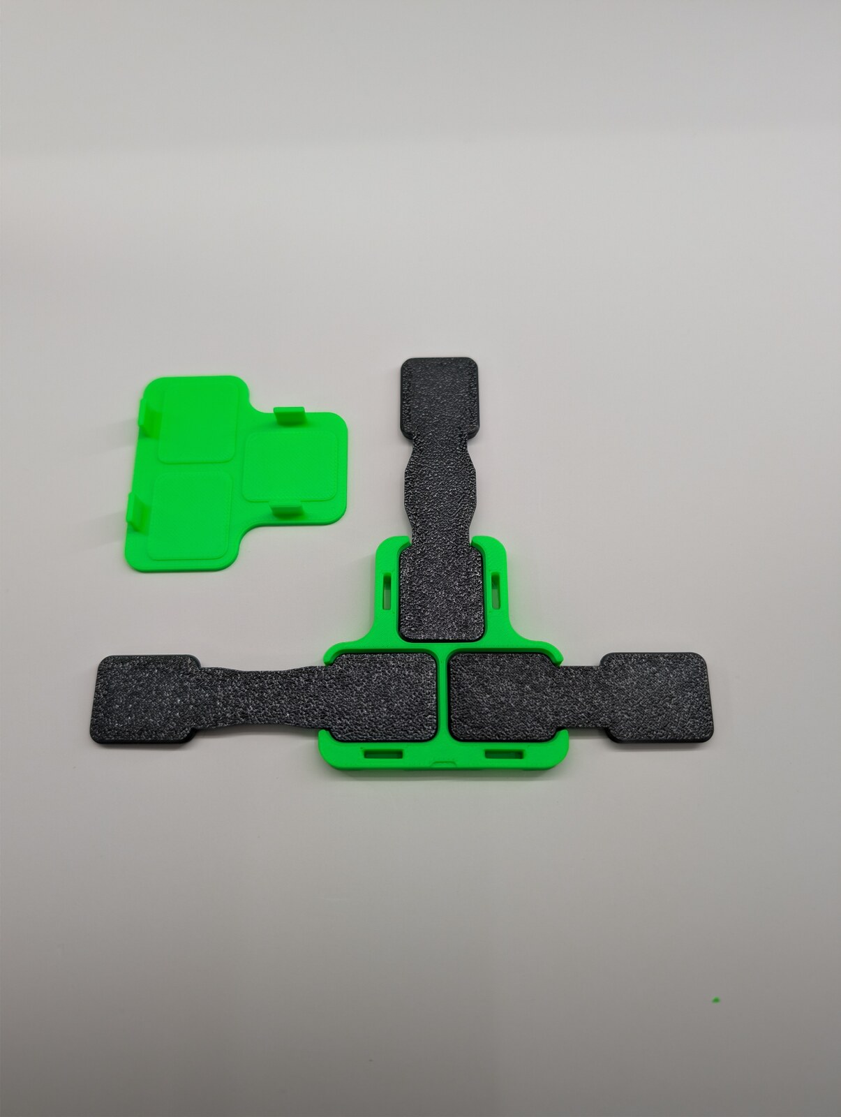 Three straps placed in a real printed T joiner with its separate cap.