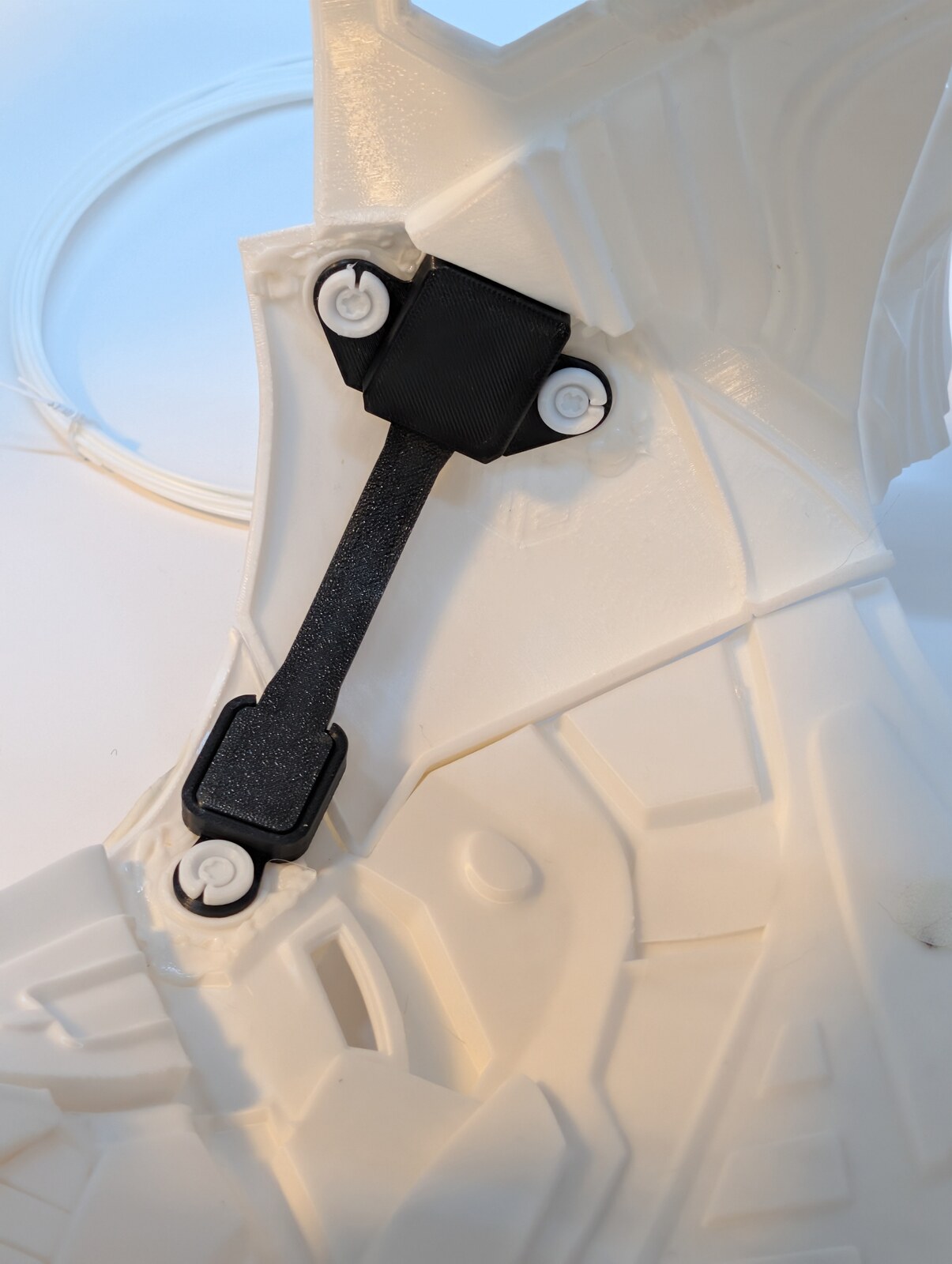 Close view of black printed straps and installed mounts inside the white printed torso armour.