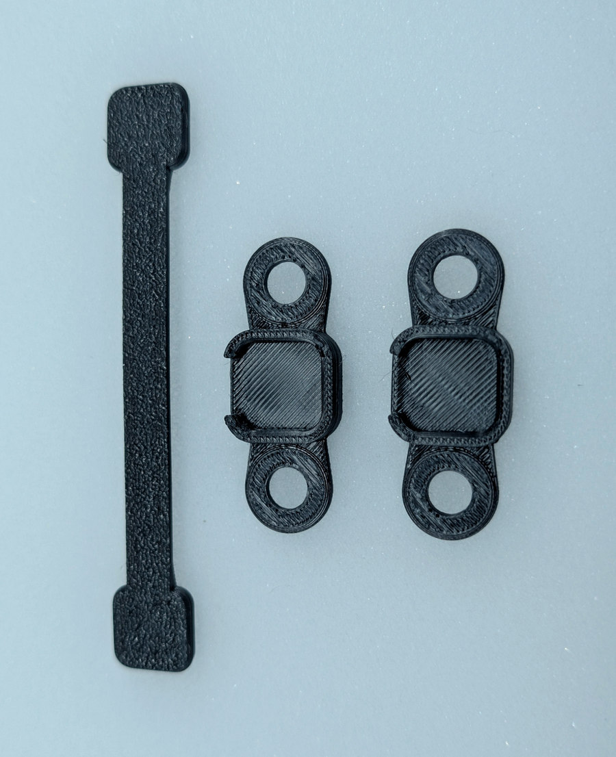 Mini flat strap beside two Mini M2 bases.